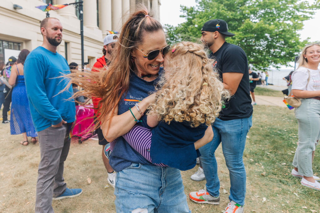 Power employee hugs her daughter at the company's Pride event.