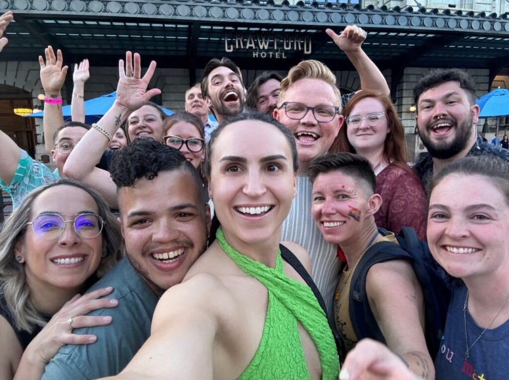 employees pose for selfie at Pride event