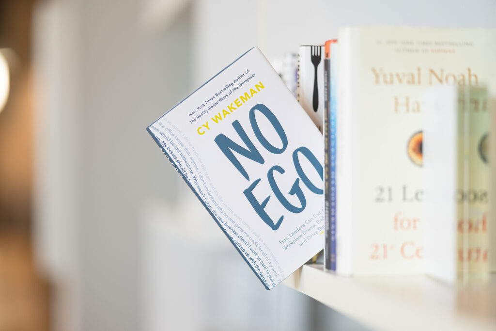 No Ego book is photographed on a book shelf.