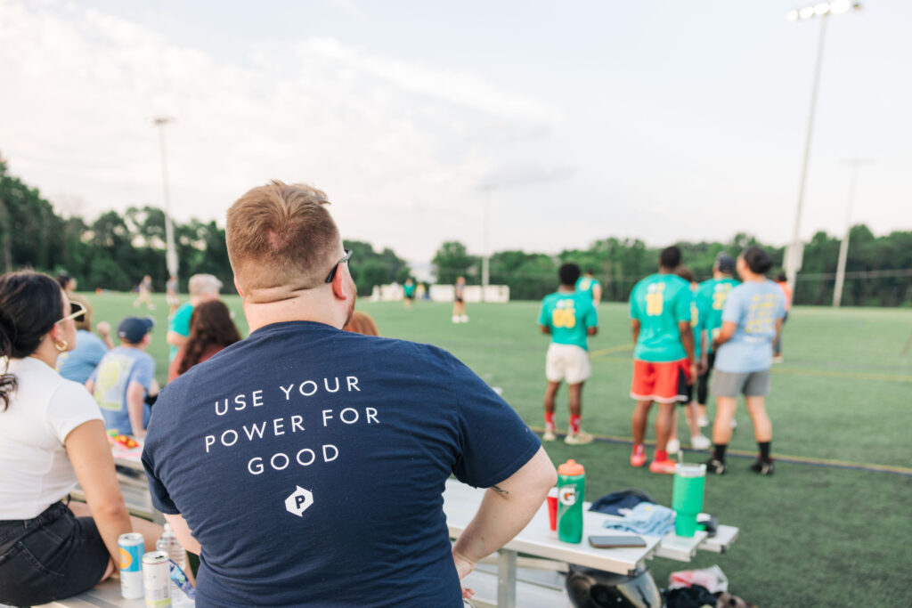 A POWER employee spectates during the company's annual Alex's Kickball tournament to raise money for childhood cancer.