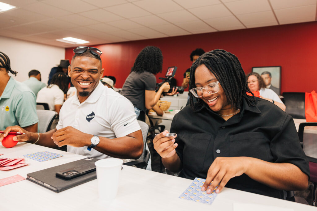 Two employees part of POWER's B.E.R.G participate in a speed-networking session for young high school scholars part of The Urban League's Scholarship Program.