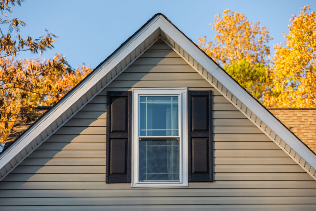 A window with fall leaves in the background.