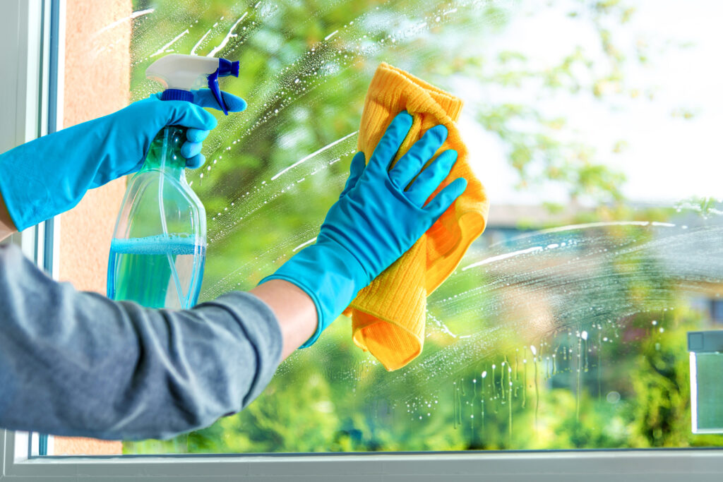 A homeowner washing a window.