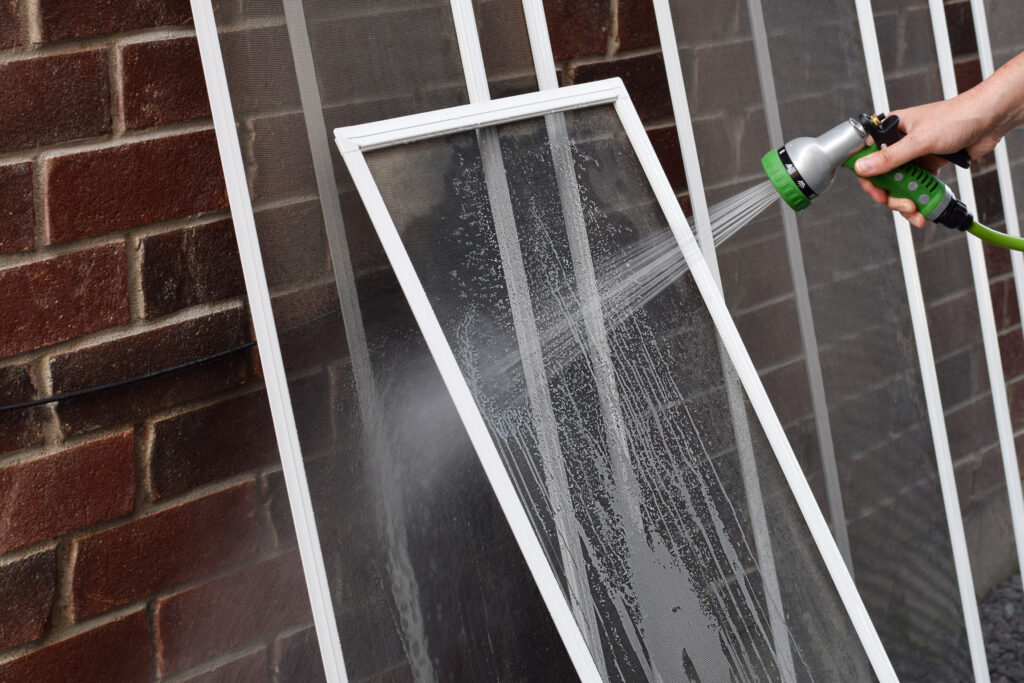 Cleaning window and door screens with low pressure is essential in fall maintenance prep work.