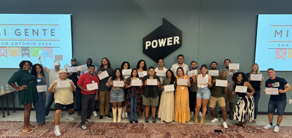 Employees pose for a group photo in POWER's San Antonio office on day 1 of their Mi Gente event.