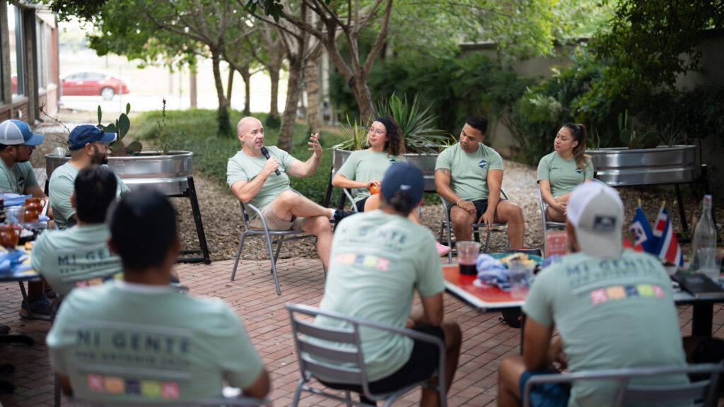 POWER Mi Gente members participate in a group breakout session outdoors to reflect on their experience thus far.