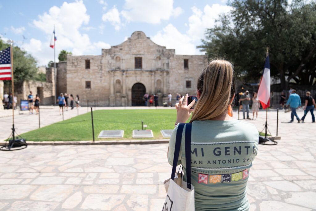 A POWER employee captures a photo of the Alamo in San Antonio during the company's Mi Gente event.