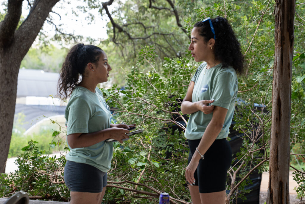 Two female employees have a one-on-one conversation after a group breakout session. 