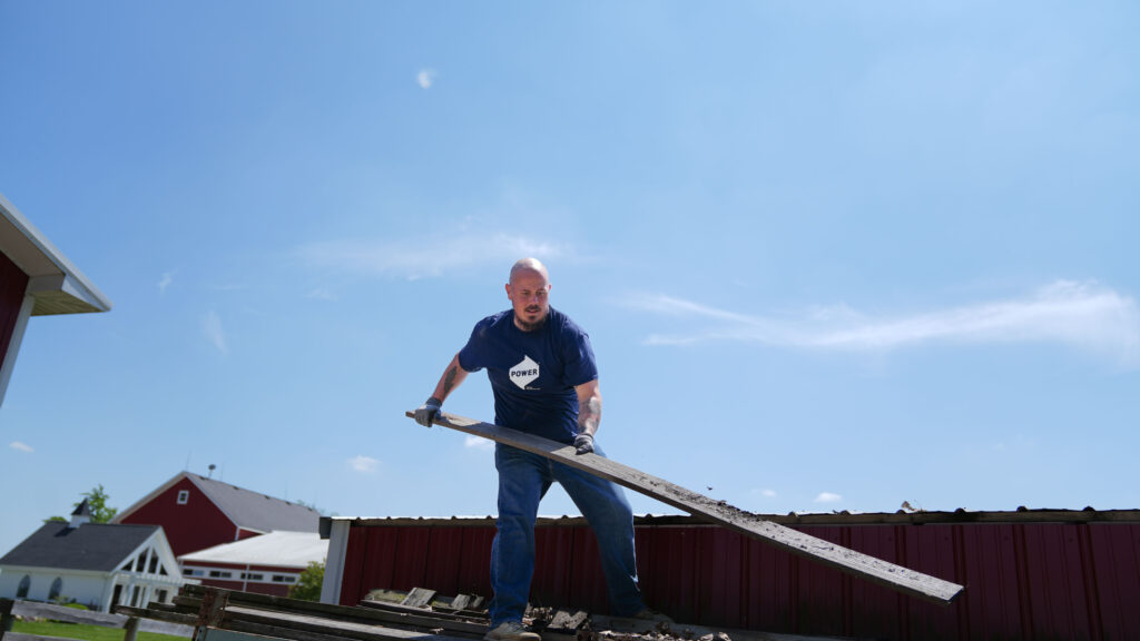 A POWER employee helps to clean up the BraveHearts ranch during  a volunteer initiative. 