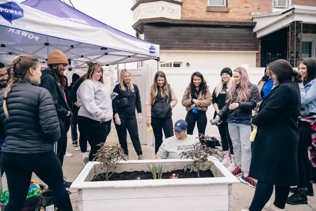 The Power Women's Initiative volunteer with Yeah Philly to paint planter boxes. 