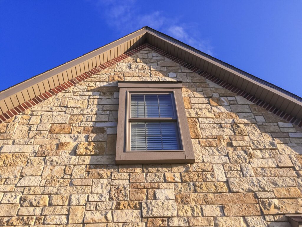 A home with stone veneer on the front is one of the popular siding options homeowners choose for their home. 