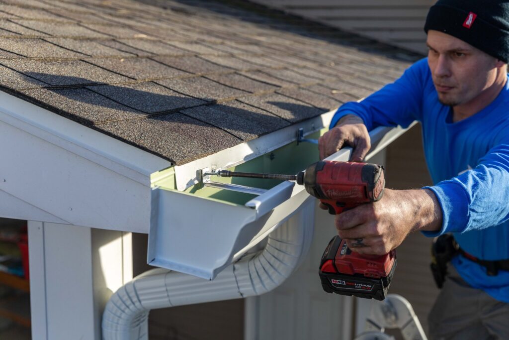 A POWER installer finishing up a gutter project.
